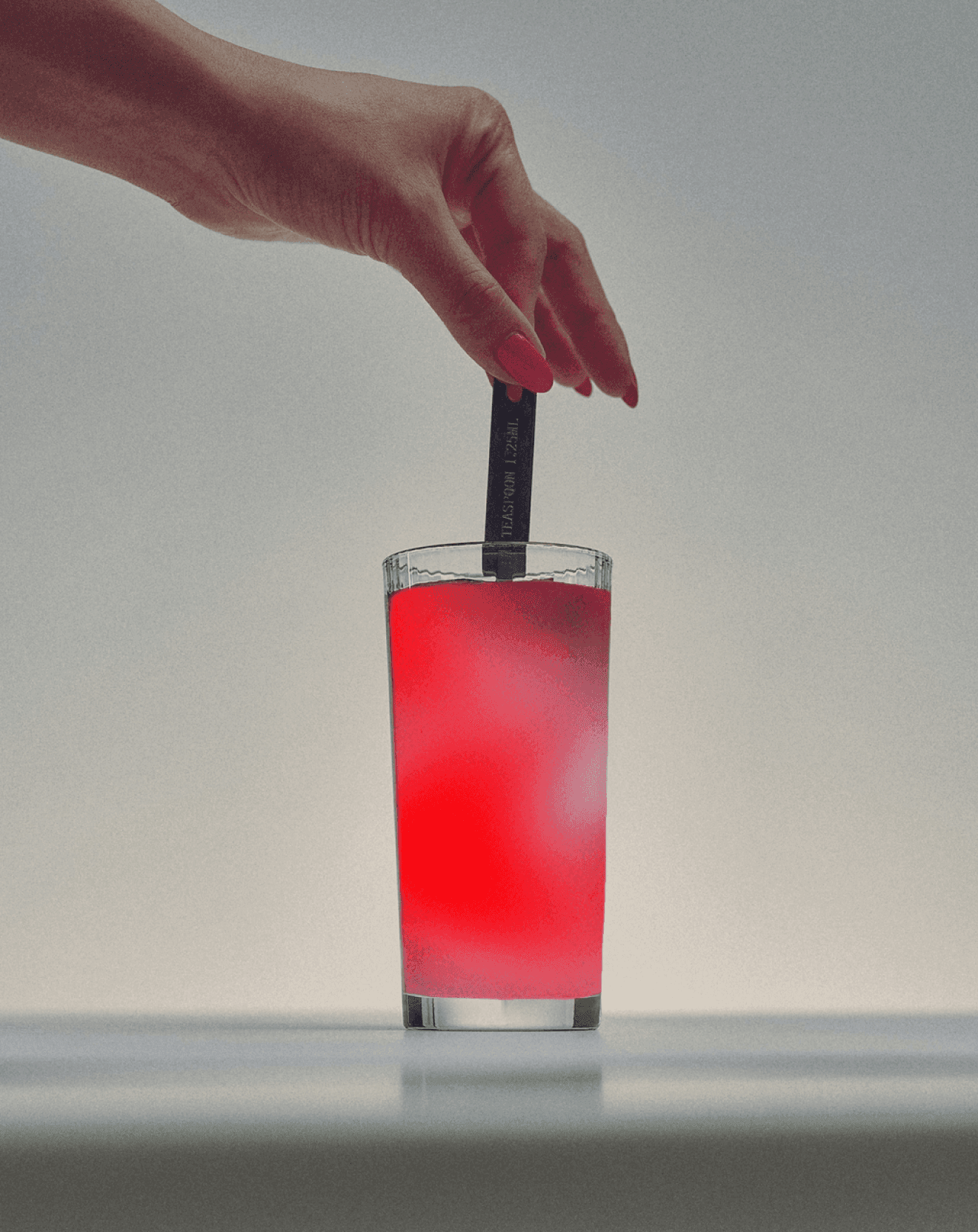 Image of stirring a red cup